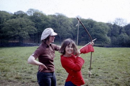 Daphne Neville, who won many archery prizes, teaching Lesley Bennett (Peggy Blackett).